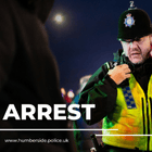 Image of police officer arresting two people
