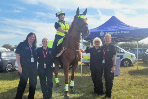 Photo of Community Safety Mounted Volunteer on horseback with other volunteers