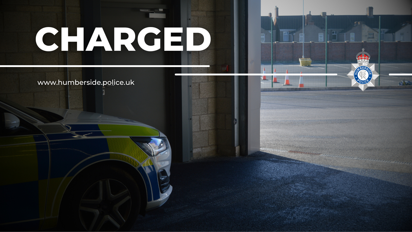 Image of police car leaving custody