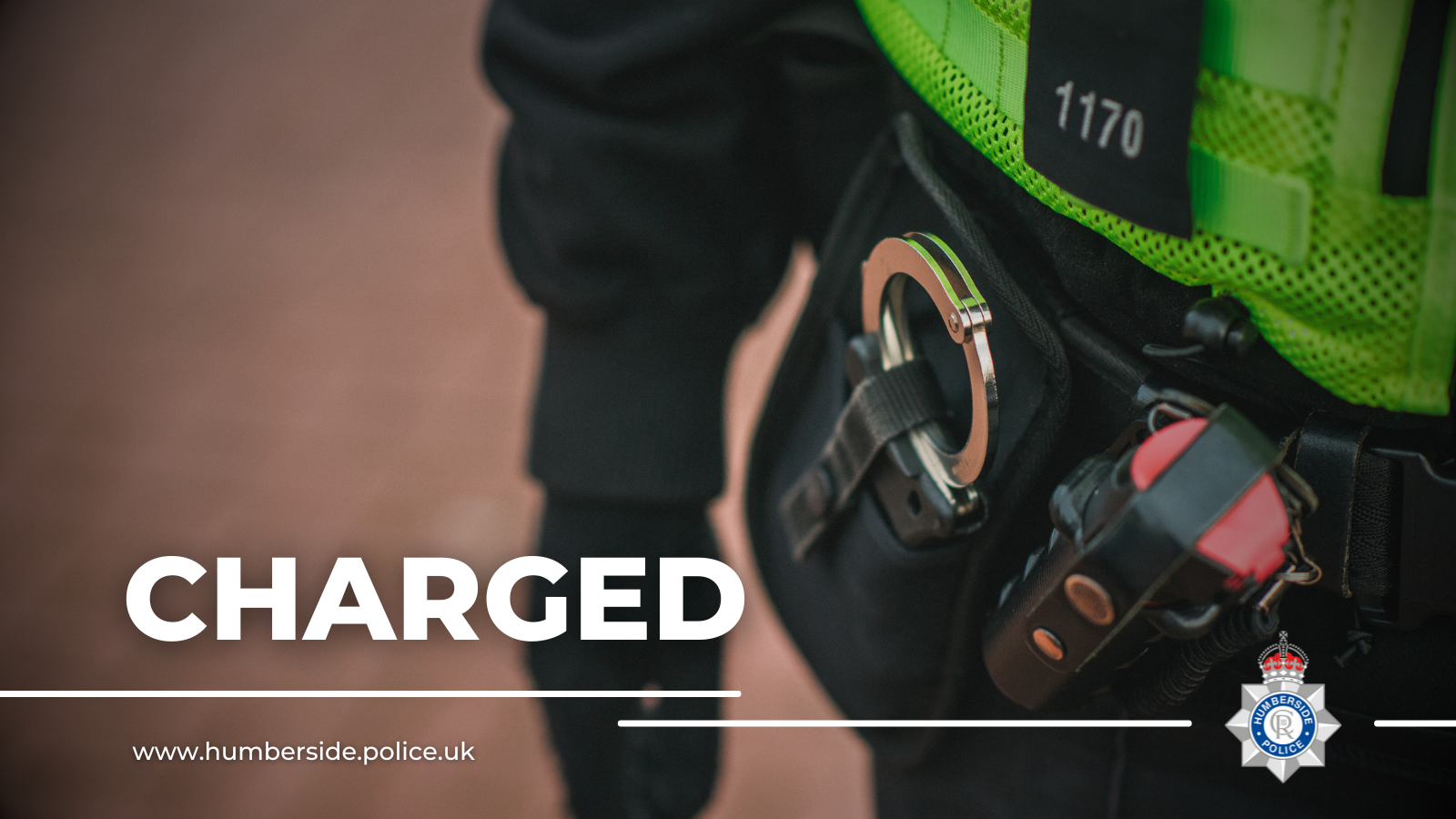 Close up of officer with handcuffs attached to belt