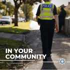 Police officer walking down street