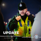 Photo of uniformed officer talking on his radio