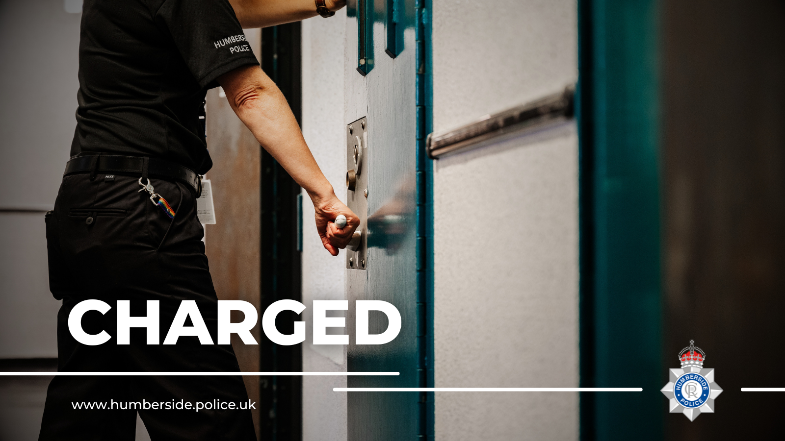 Officer shutting cell door with word 'charged' written on the image
