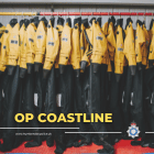 Image of marine unit wetsuits hung on a rail with the words 'Op Coastline' written across the image