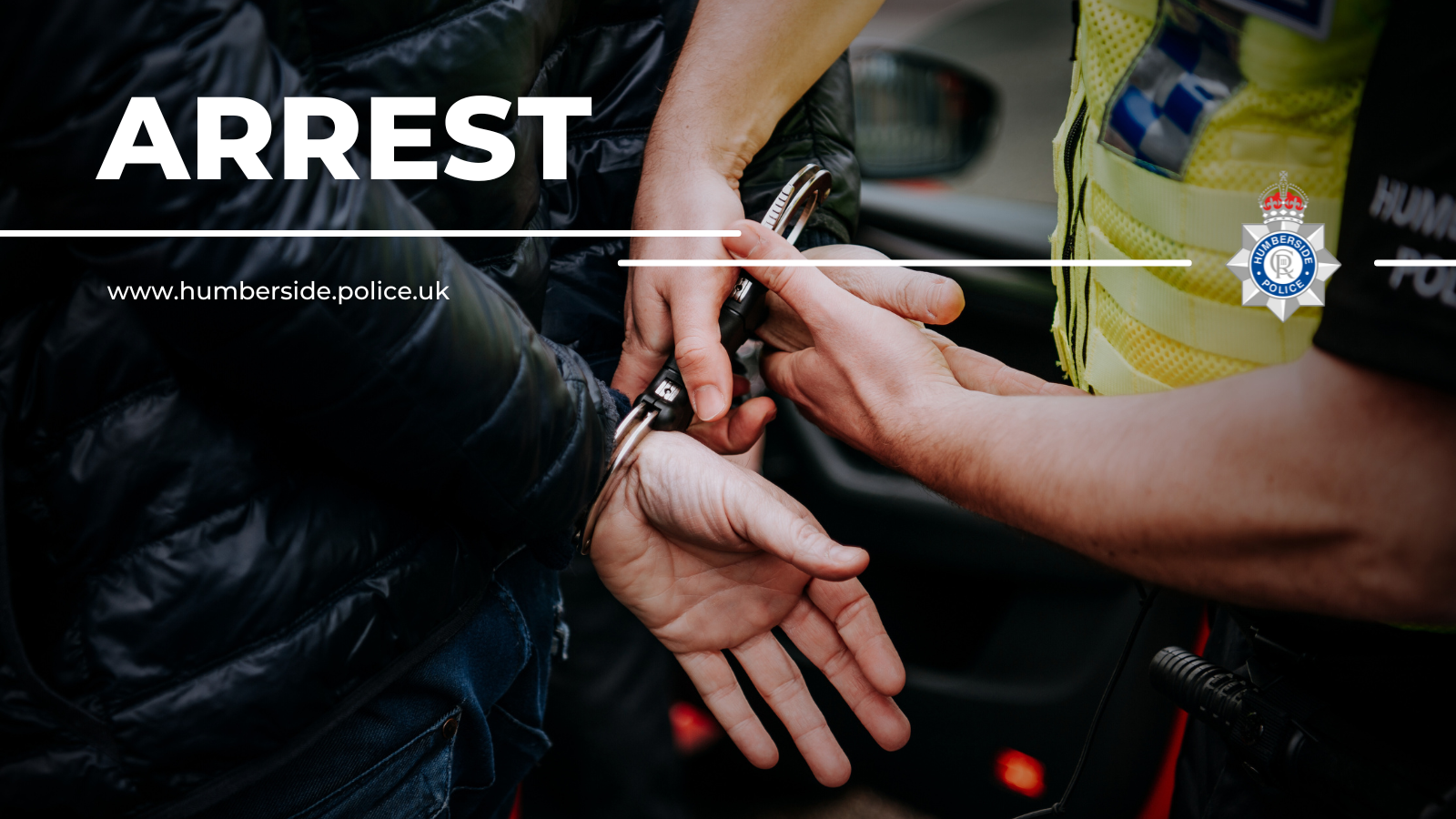 Close up image of officer putting cuffs on suspect