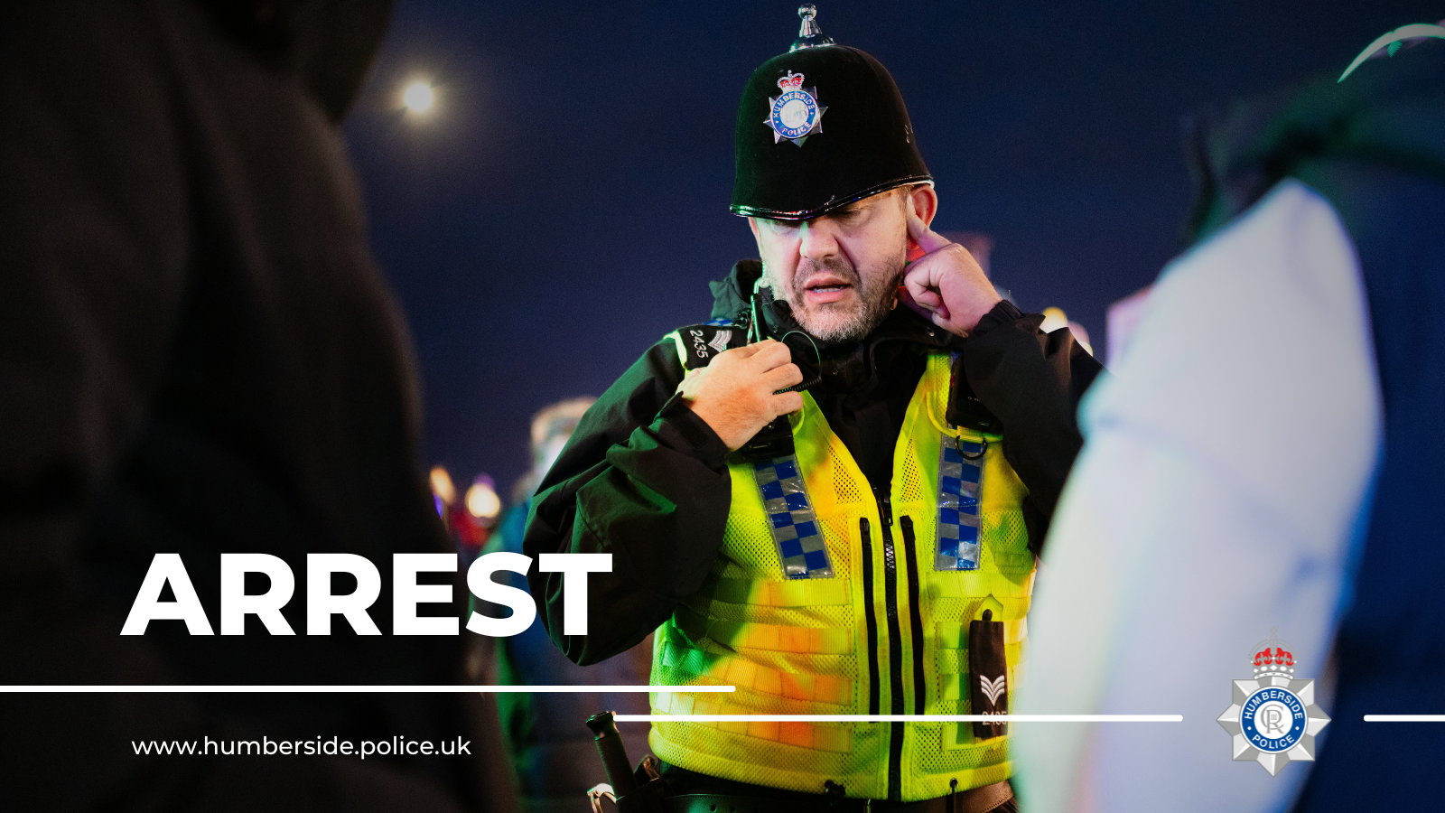 Image of police officer arresting people at night